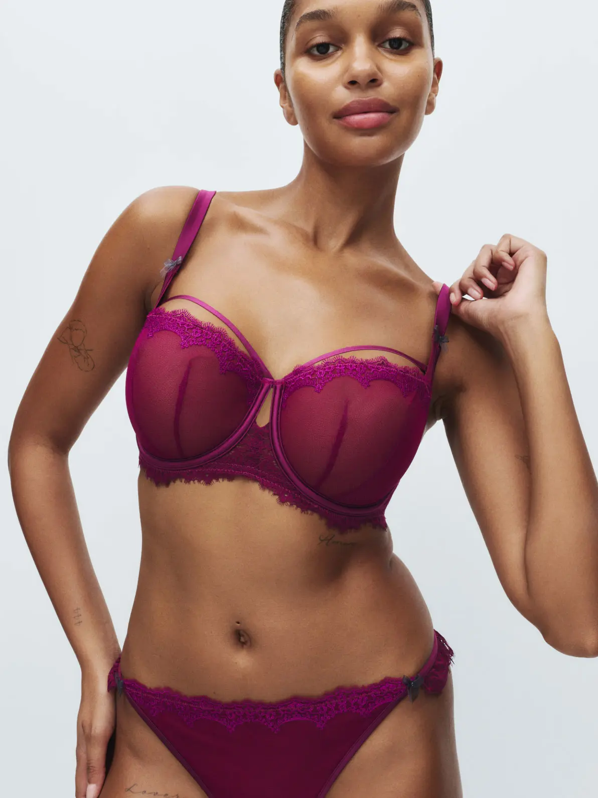 Woman wearing magenta bra and underwear set 