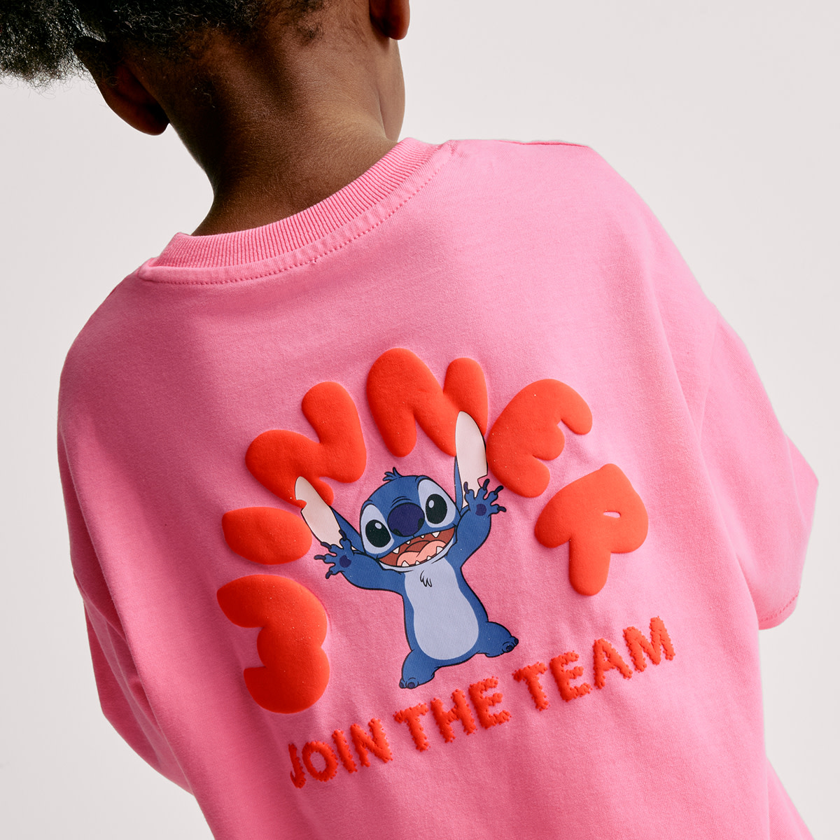 Girl wearing a pink color character printed t-shirt. Shop Character shop 