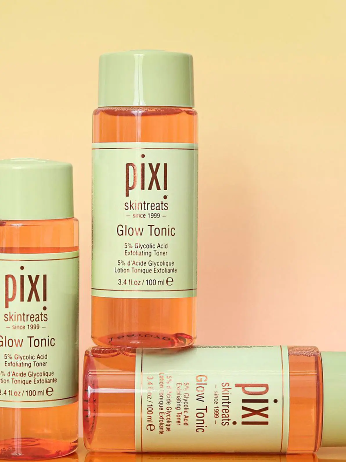 Three Pixi beauty products in orange and green packaging 