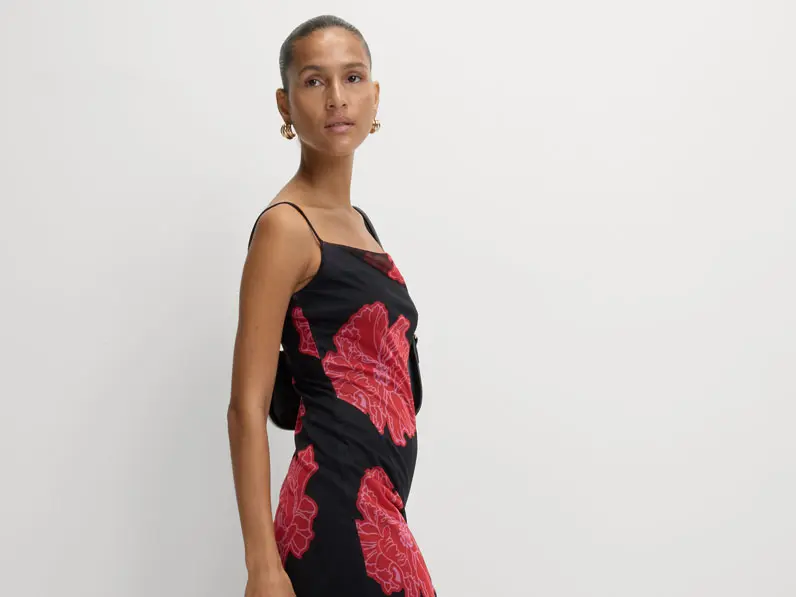Woman wearing red and black floral-print slip dress