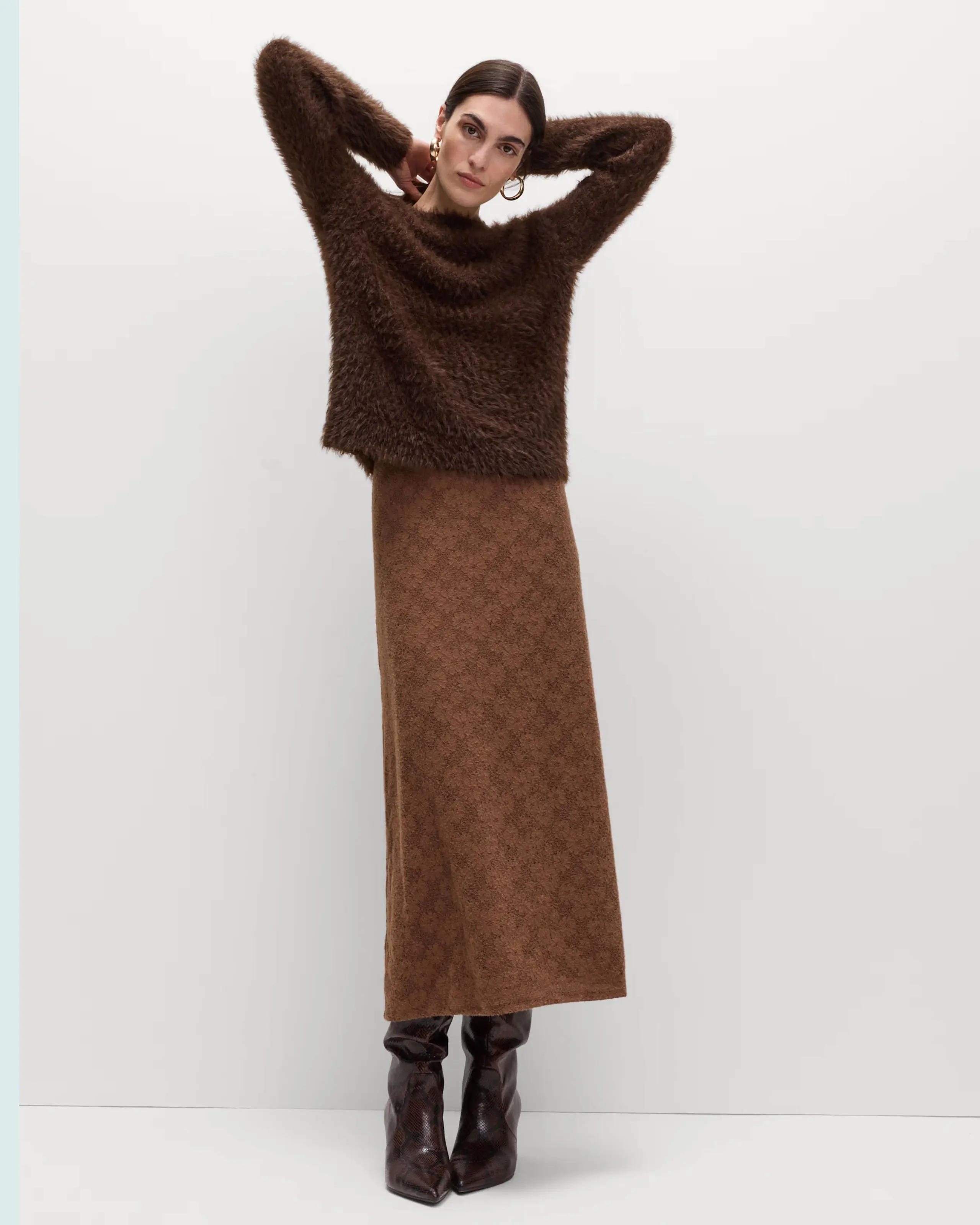 Woman wearing brown jumper and brown lace skirt