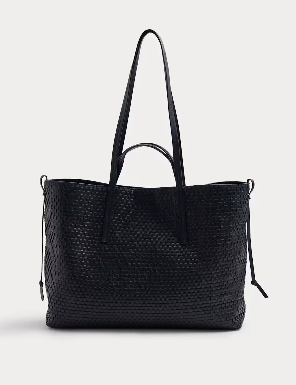 Leather navy handbag with a woven surface pattern and tabs on either side.