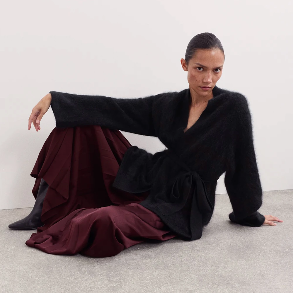 Woman wearing Rosie Huntington-Whiteley revere-collar pyjamas in buff