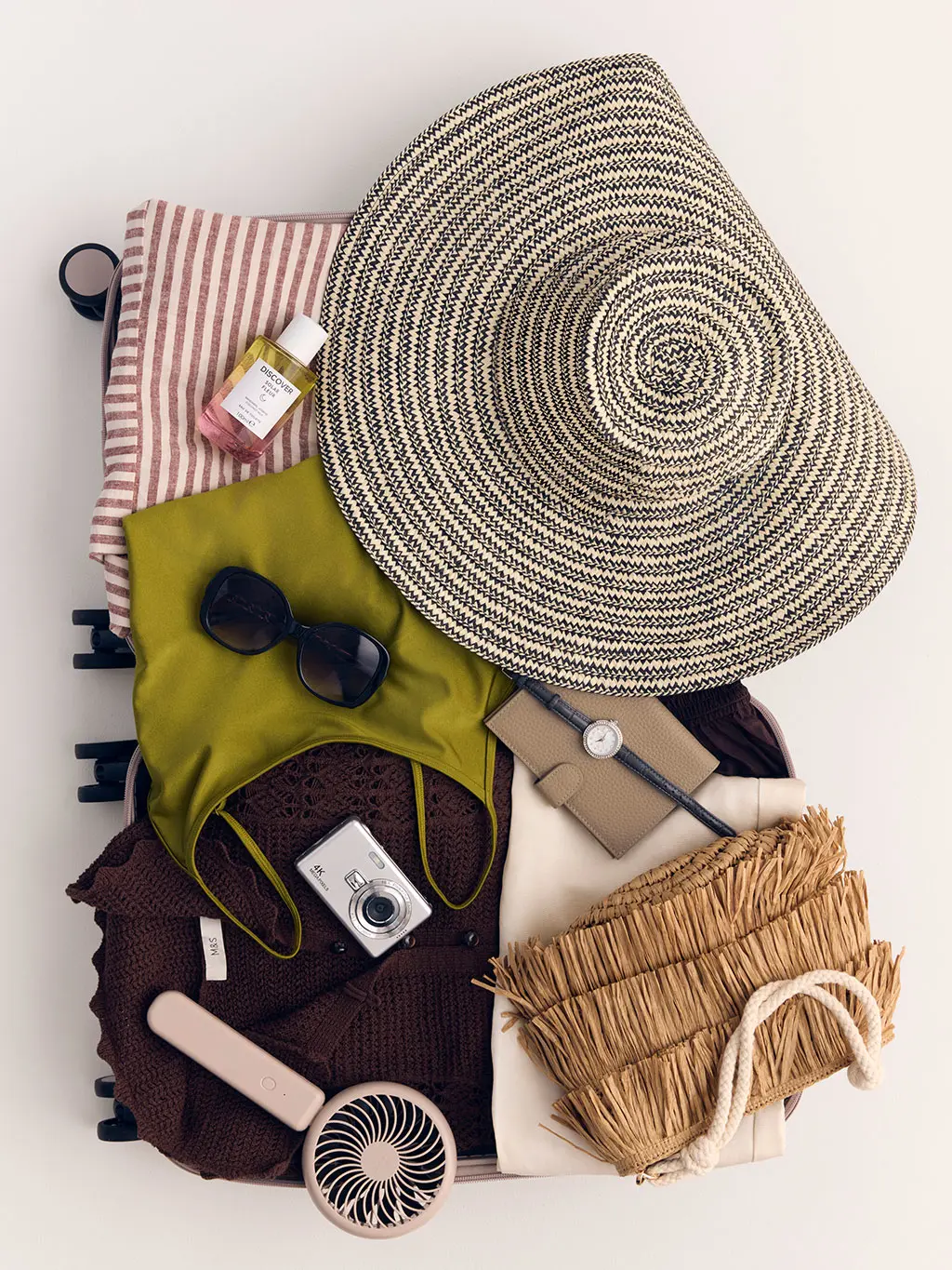 Suitcase with packing essentials for her in