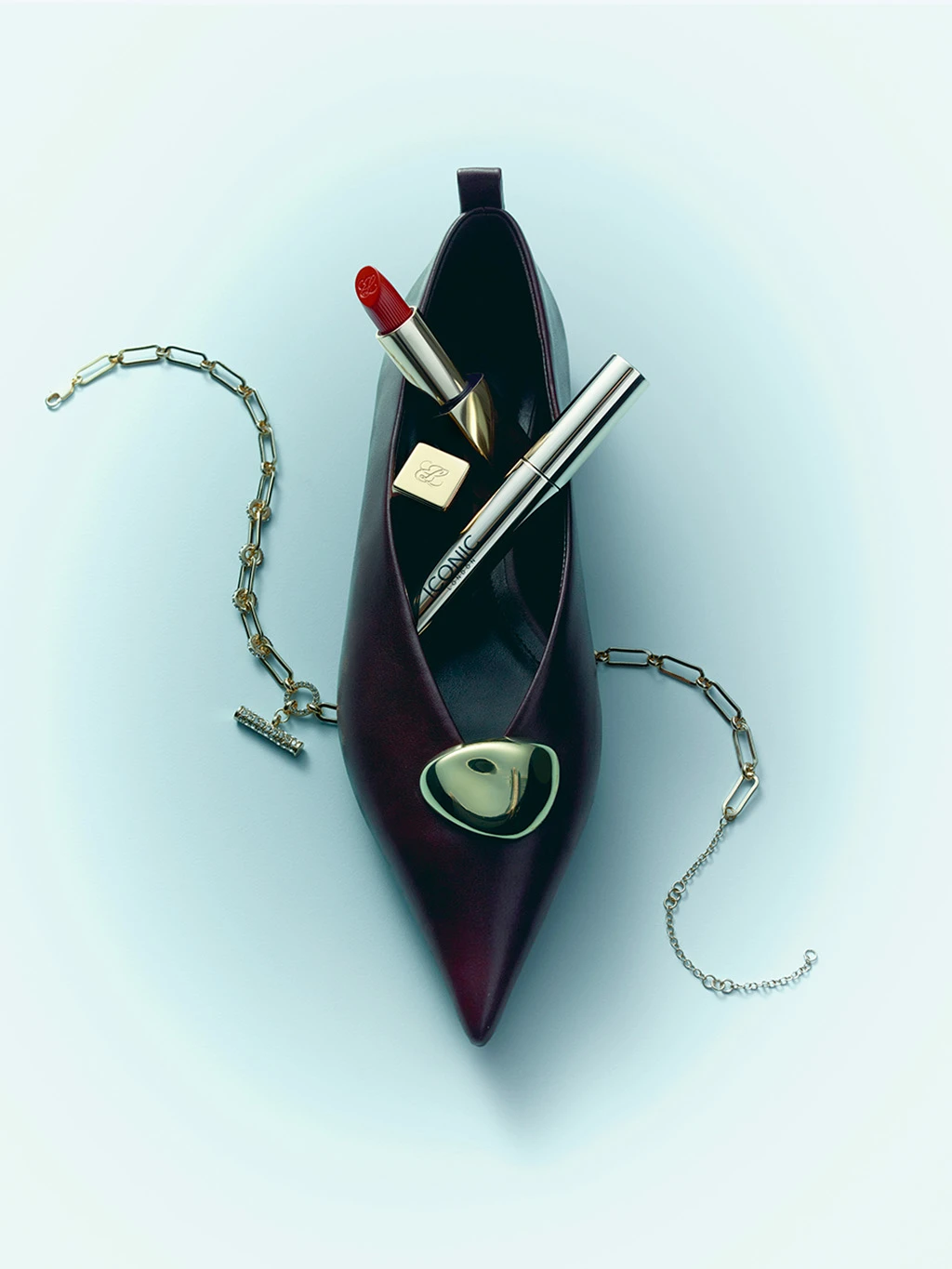 Gifting image with a burgundy shoe filled with lipstick and jewellery.