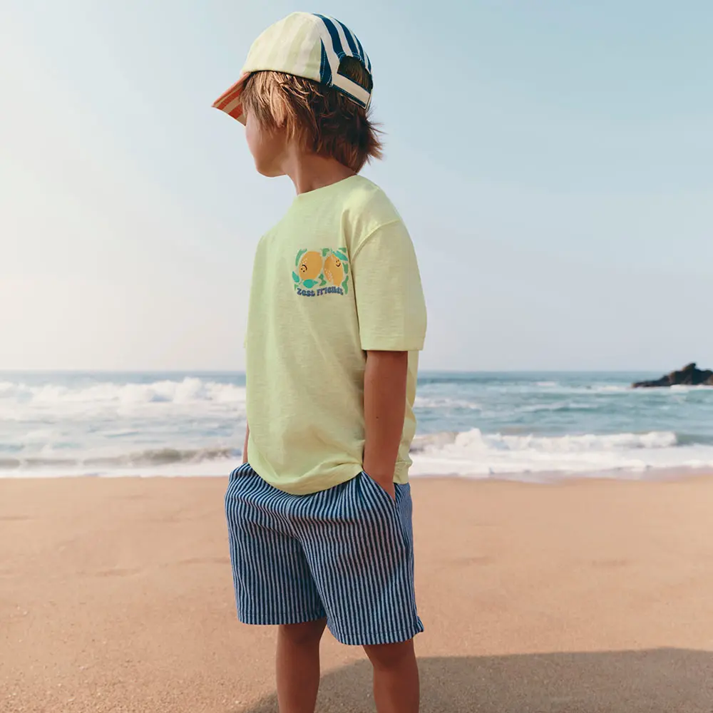Boy in baseball cap on the beach