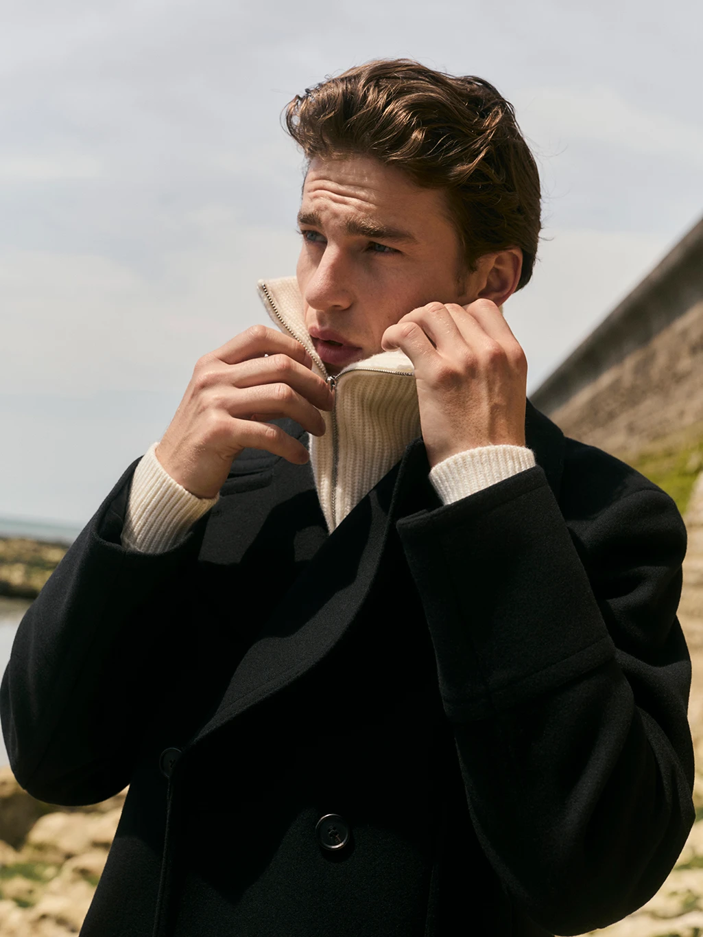 Man wearing Jaeger coat and cream lambswool zip-neck jumper