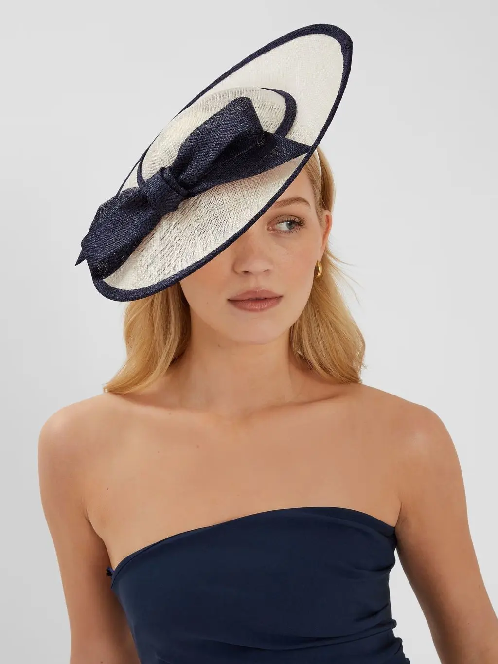 A woman wears a fascinator