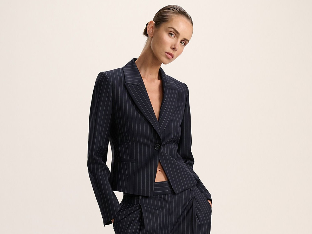 Woman wearing a navy pinstripe suit