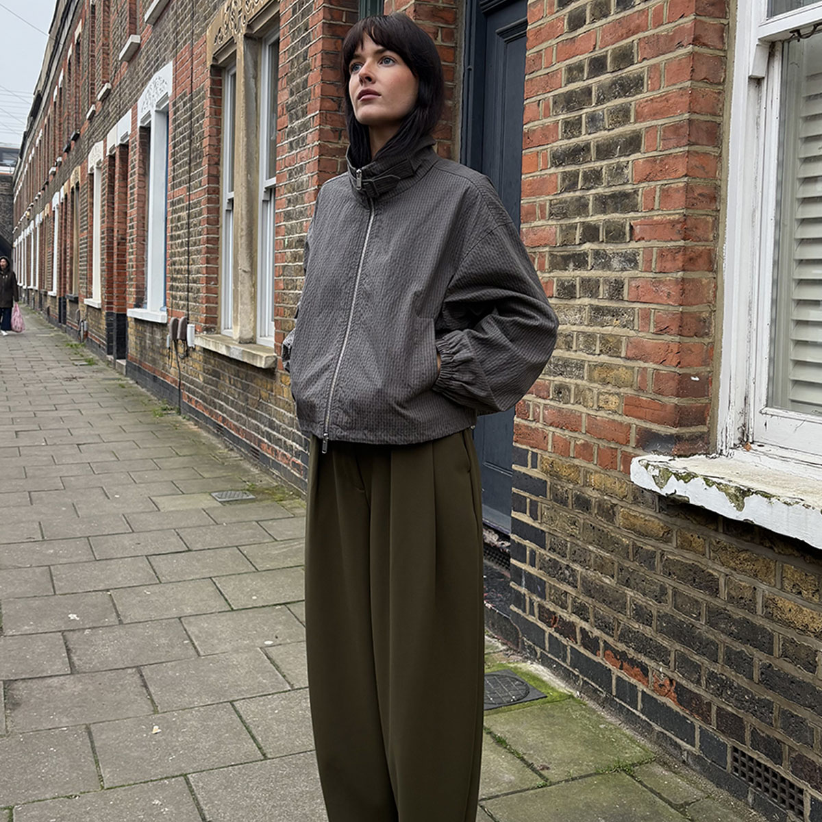 Woman wearing coat and trousers