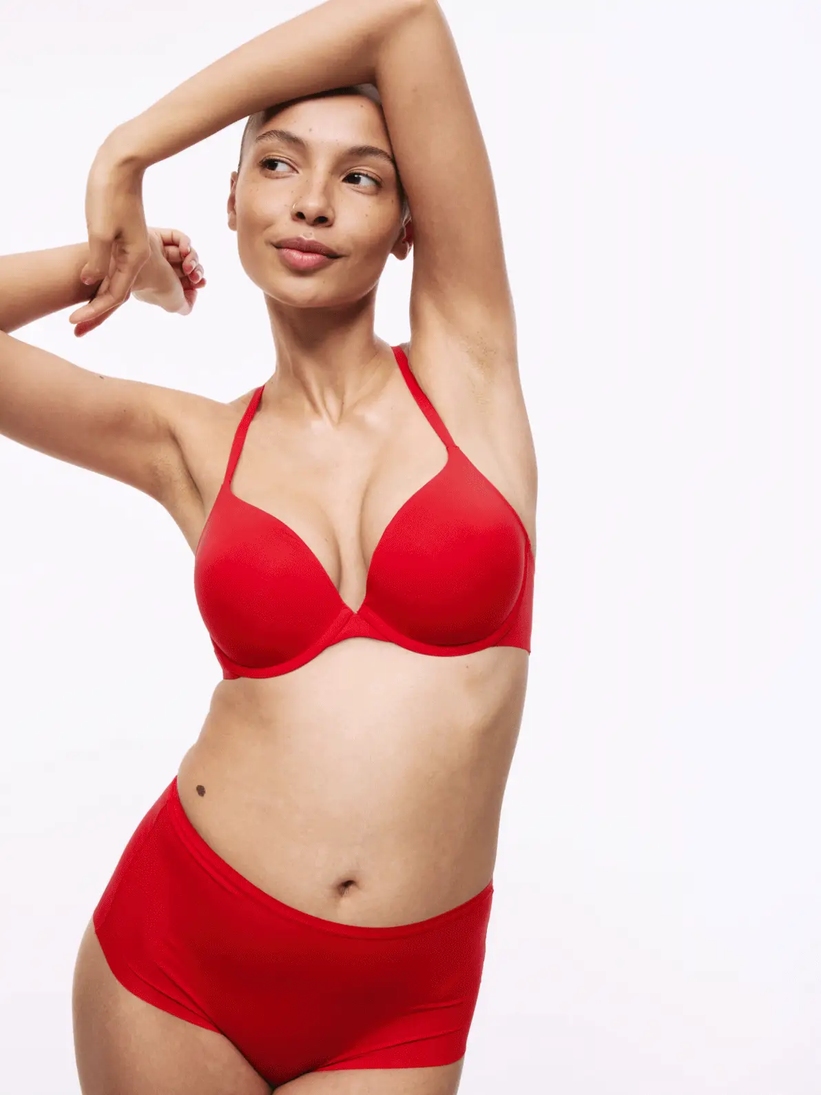 Gif of various women wearing different bra sets, one in blue, one in black and another in red