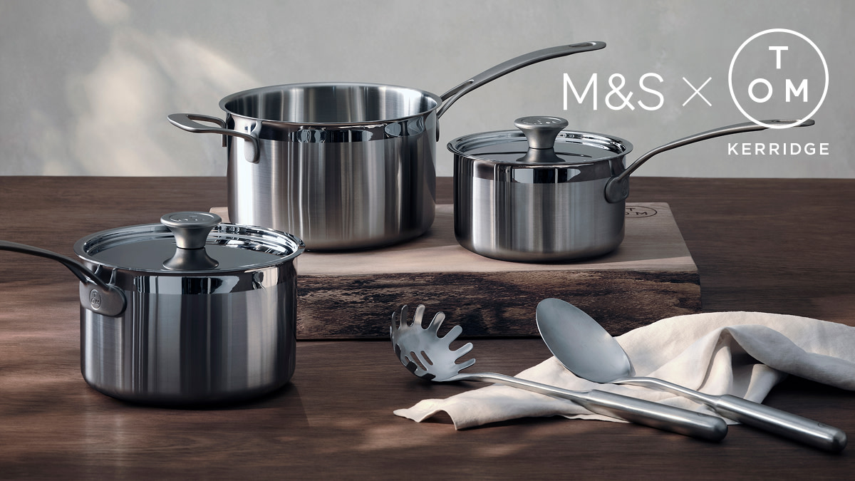 Pots and pans on wooden chopping board