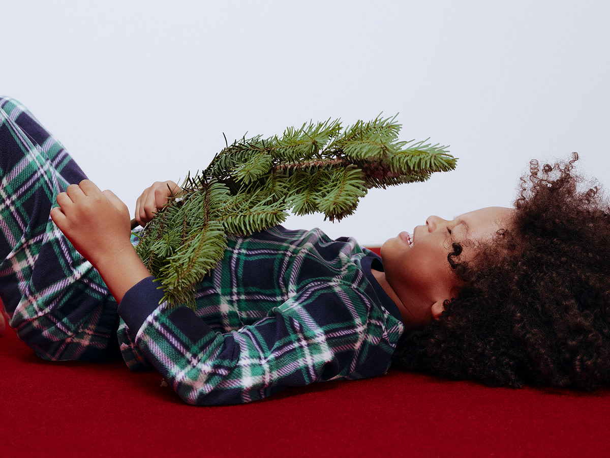 Boy wearing Christmas pyjamas at M&S