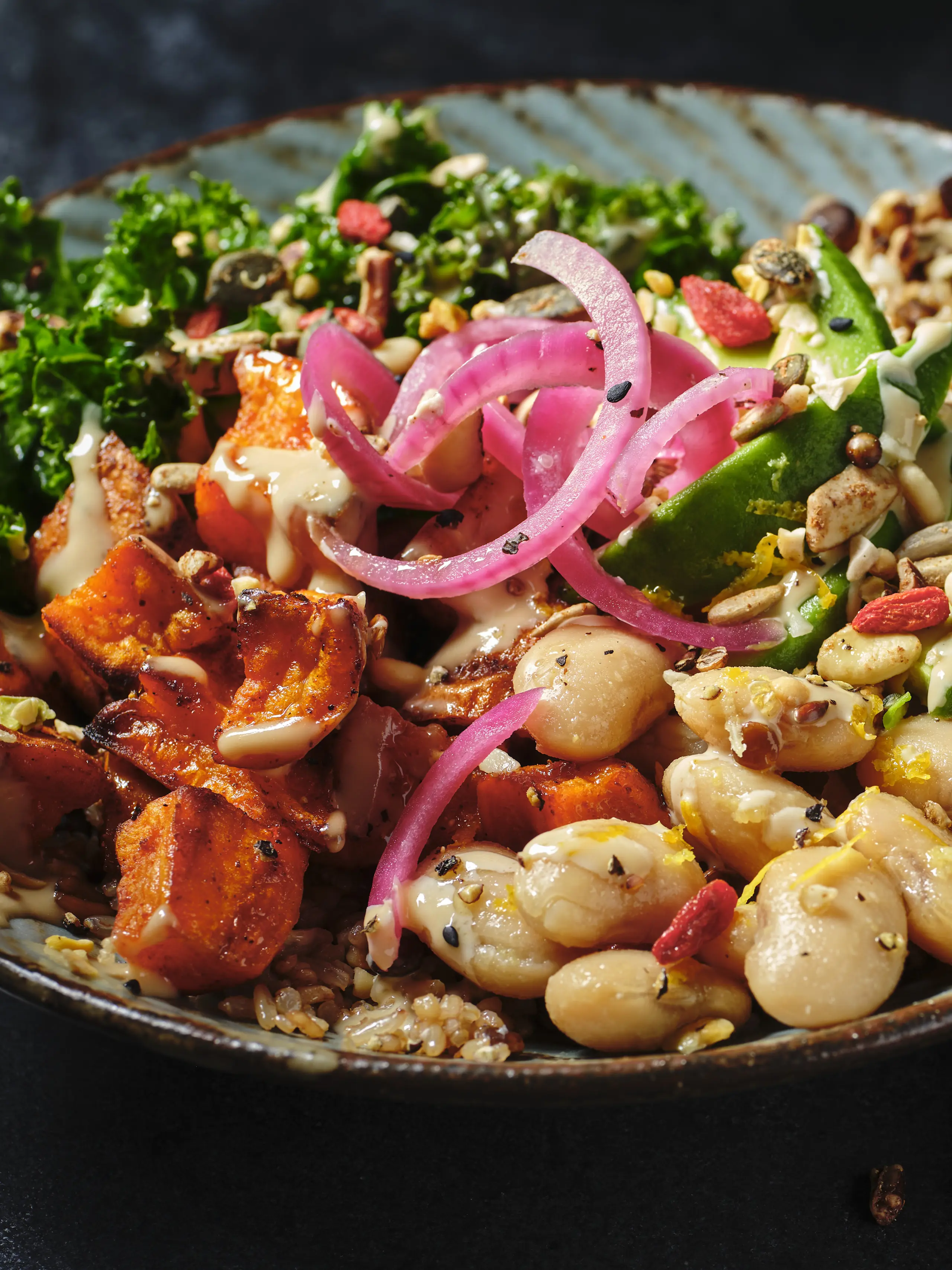 Bowl with sweet potato, butter beans, red onion and salad