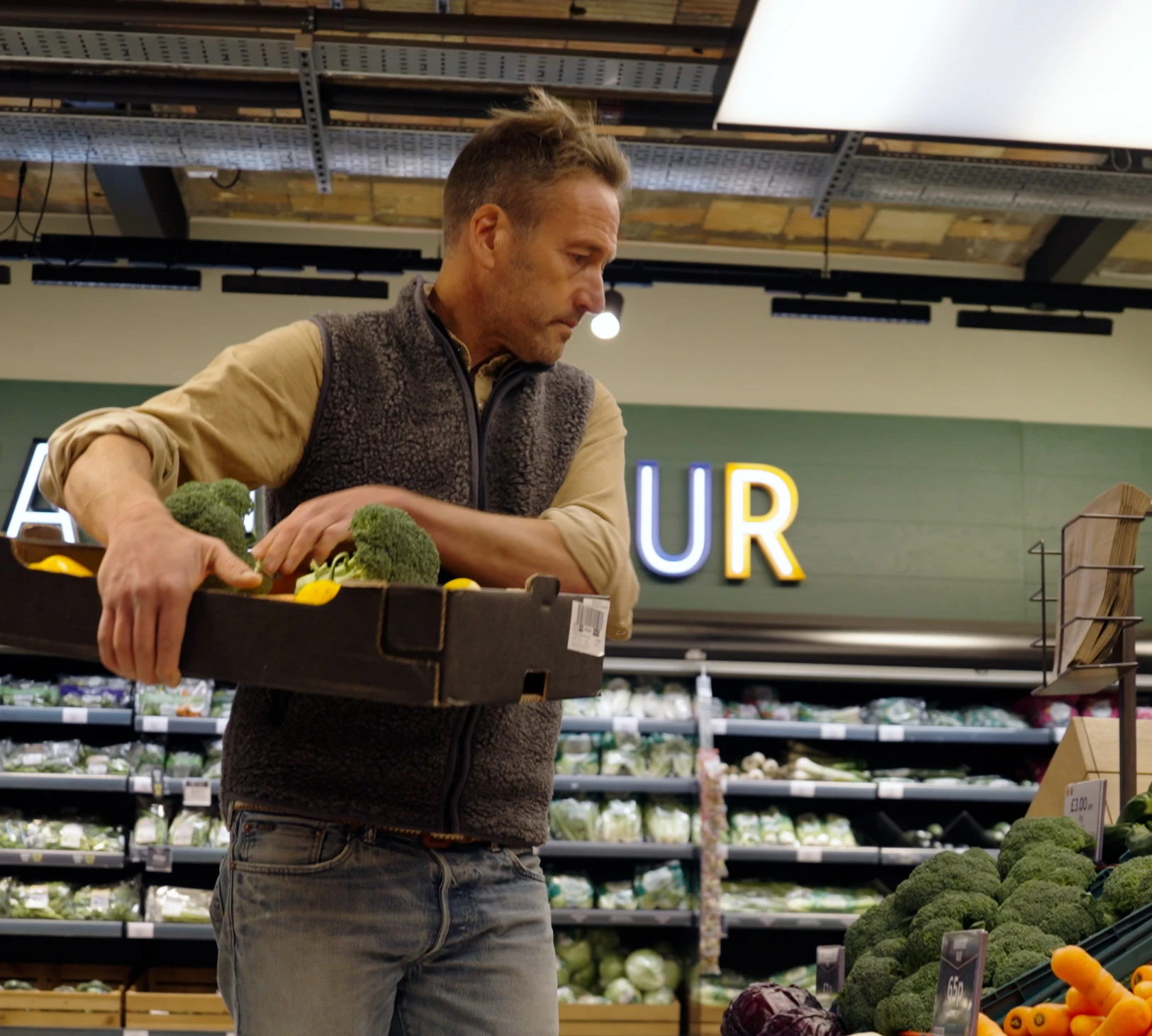 Ben Fogle collecting vegetables in an aisle of M&S