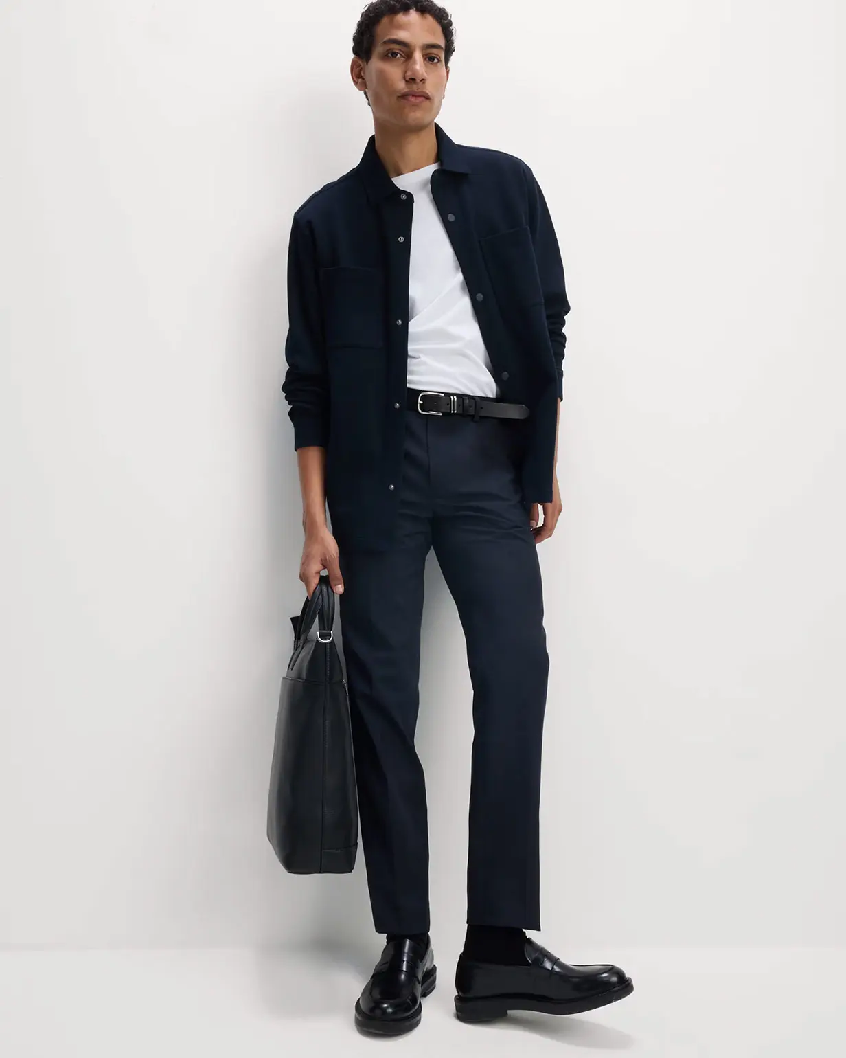 Man wearing navy shirt and trousers