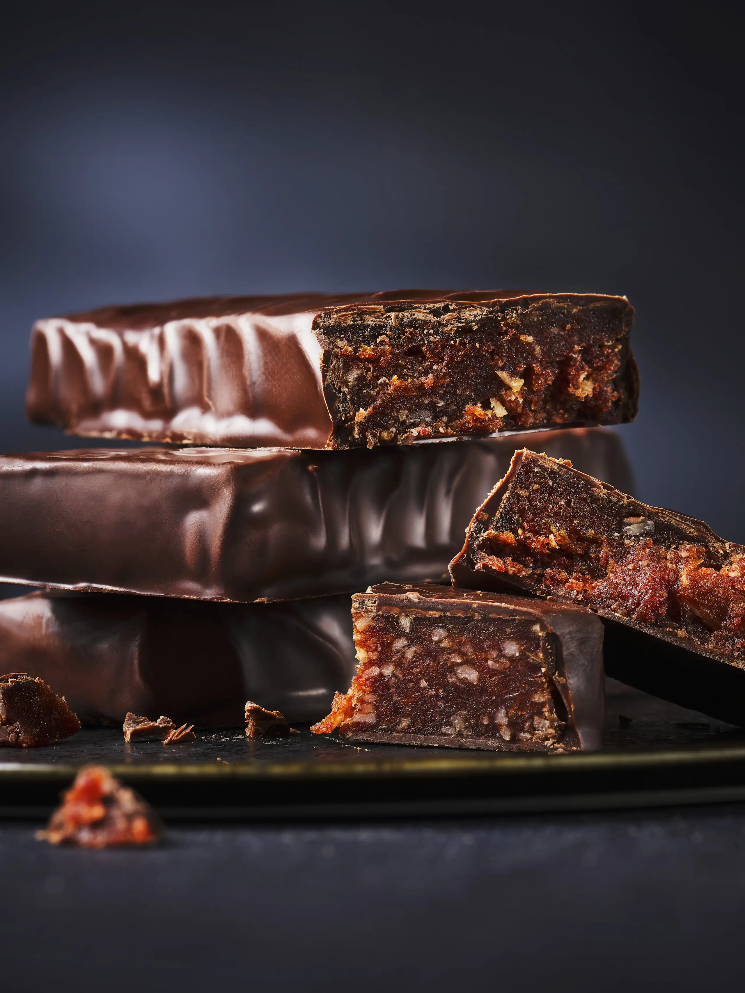 Dark chocolate date bars stacked on top of each other and sliced in half