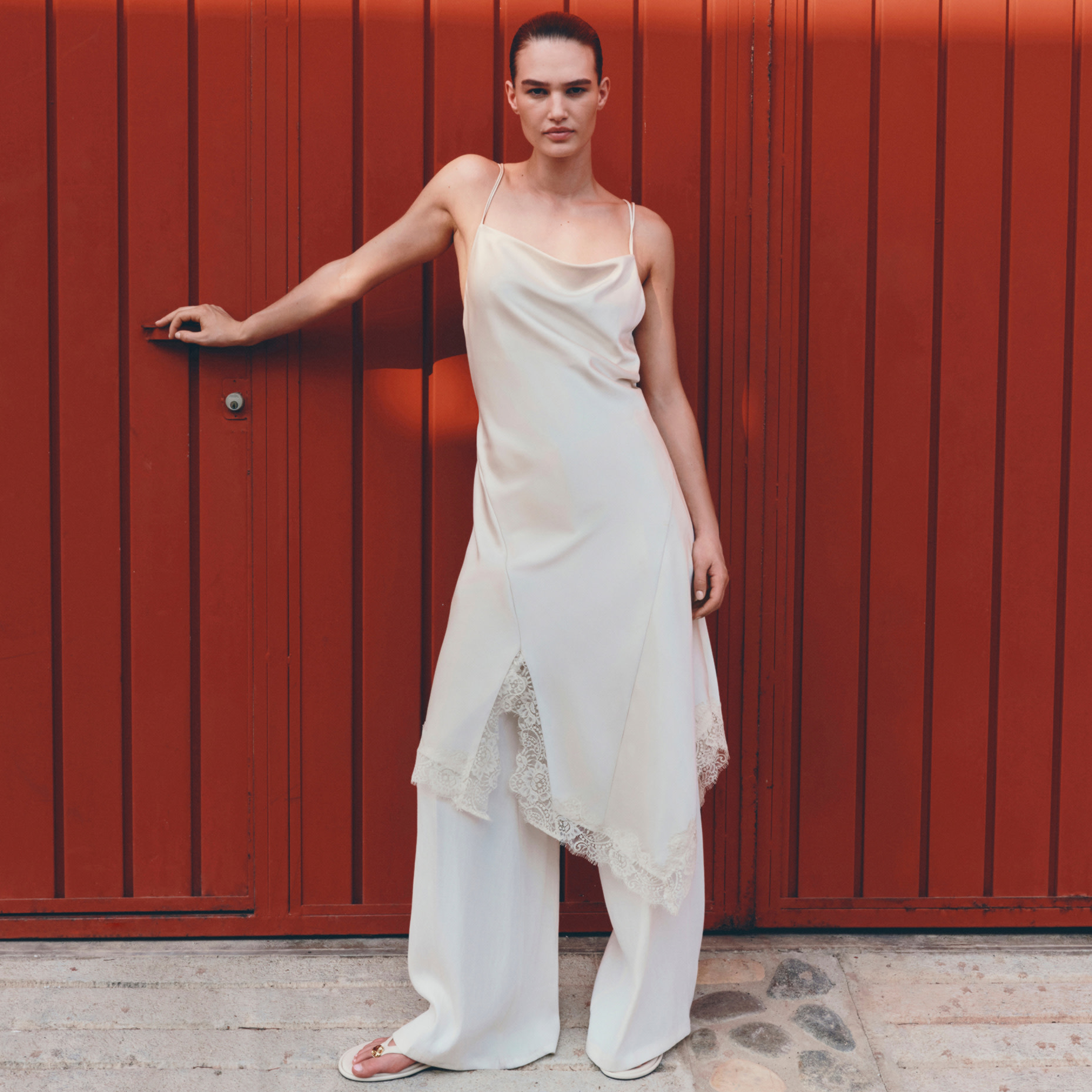 Woman in white dress and white trousers