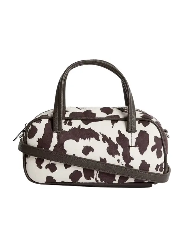 A cut out of a bowling bag in cow print by M&S