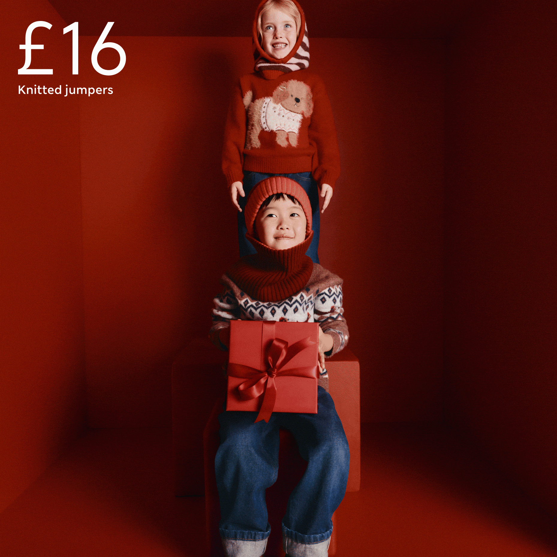 Kids in red Christmas jumpers