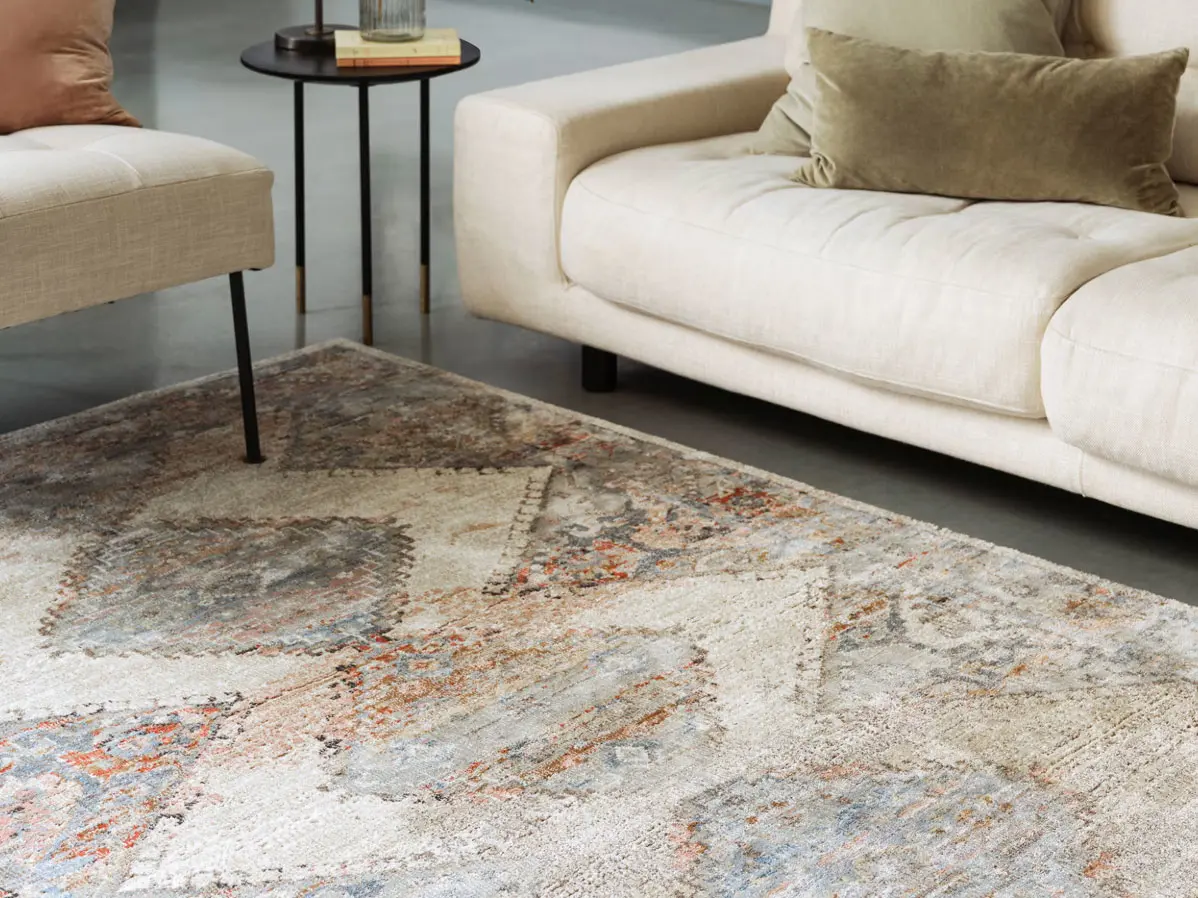 Neutral patterned rug and cream sofa