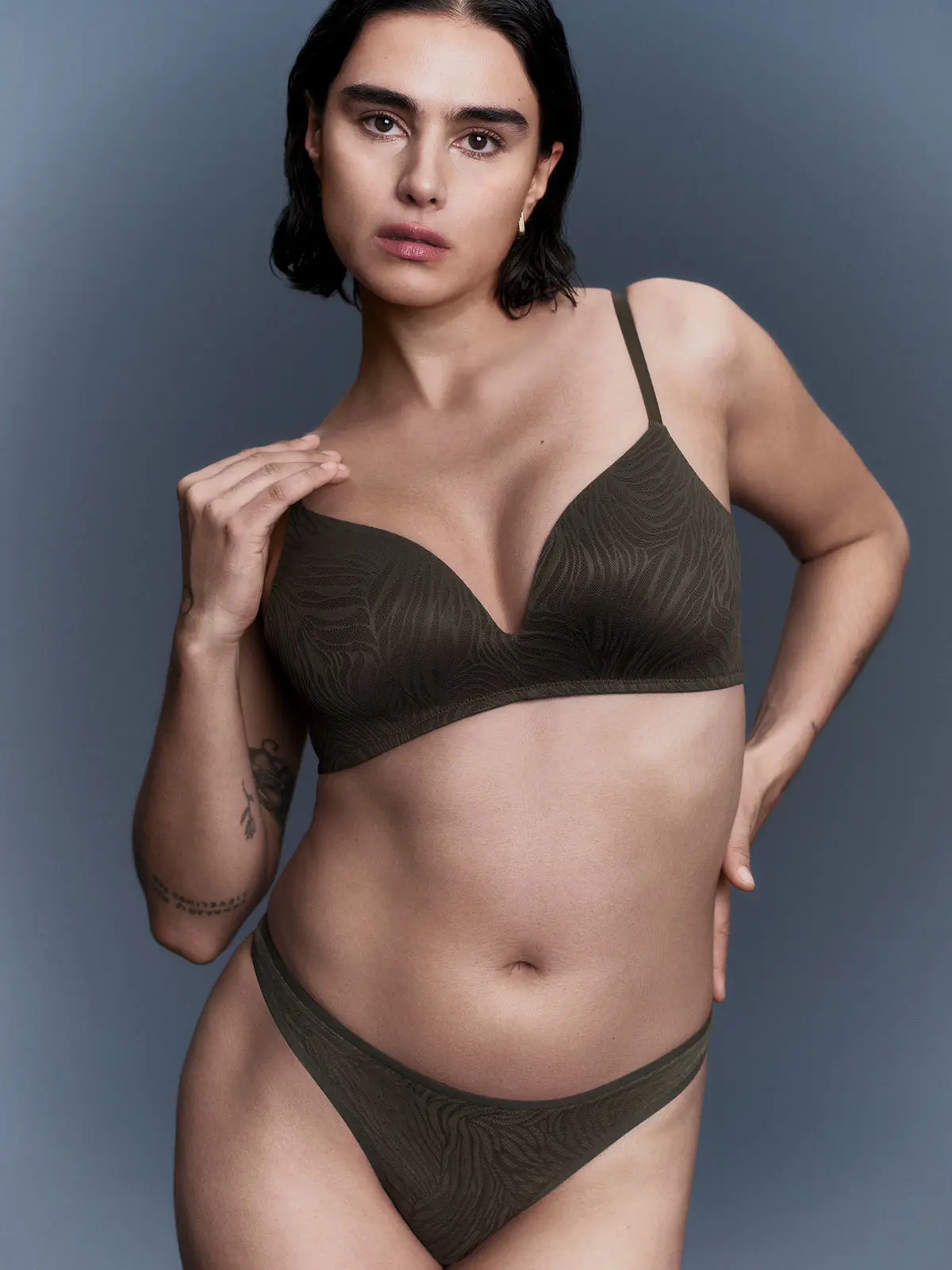 Woman in olive lace bra and underwear