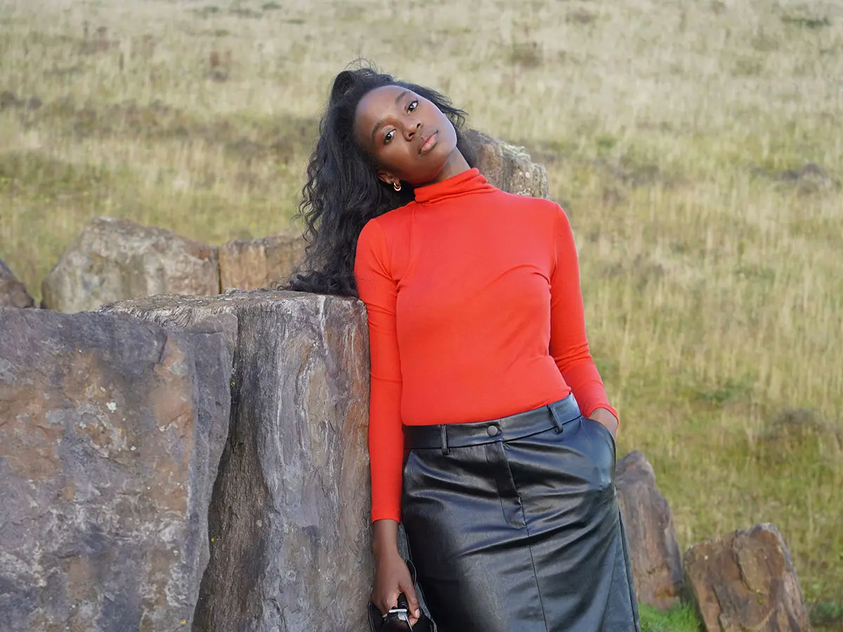 Influencer Langa Bird wearing bold red top with black leather skirt