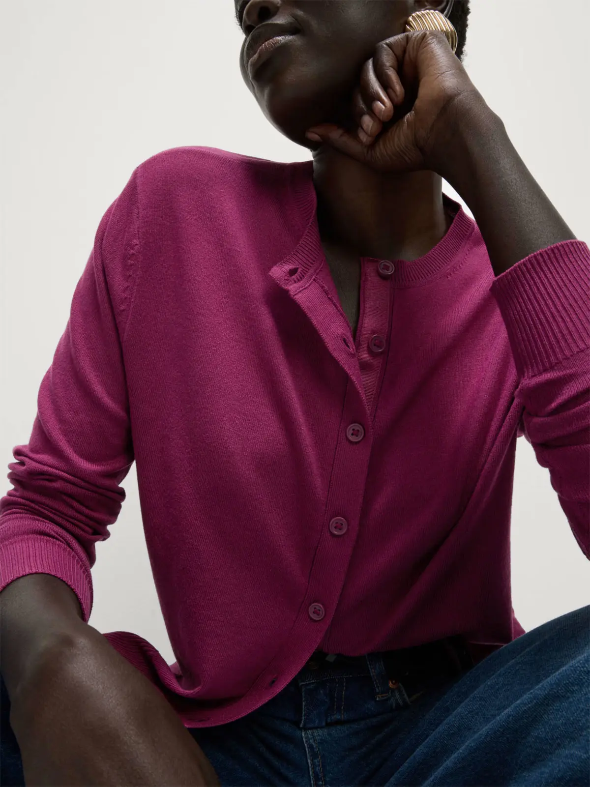 Woman wearing raspberry button-up cardigan 