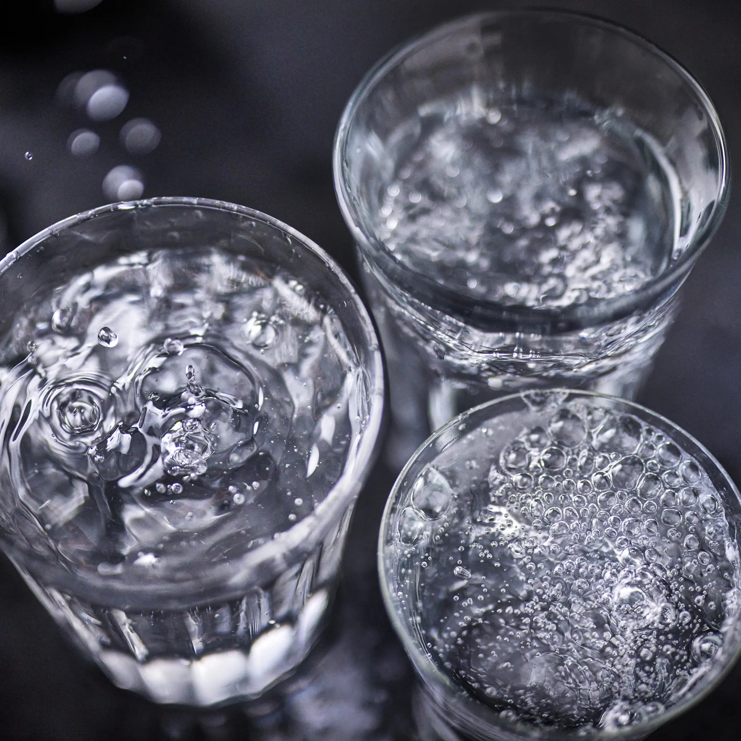 Glasses of water on black background