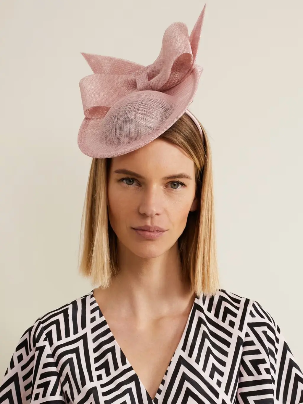 Woman wearing a pink fascinator at M&S