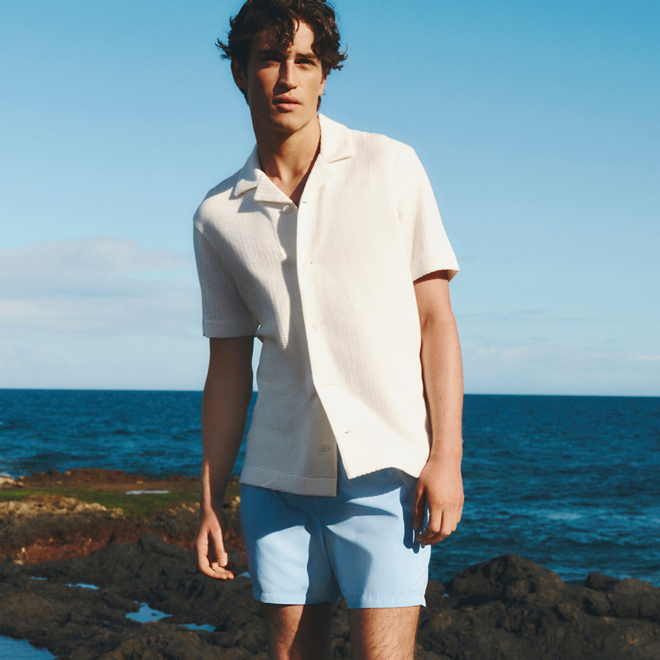  Man wearing a white shirt and Blue shorts. 