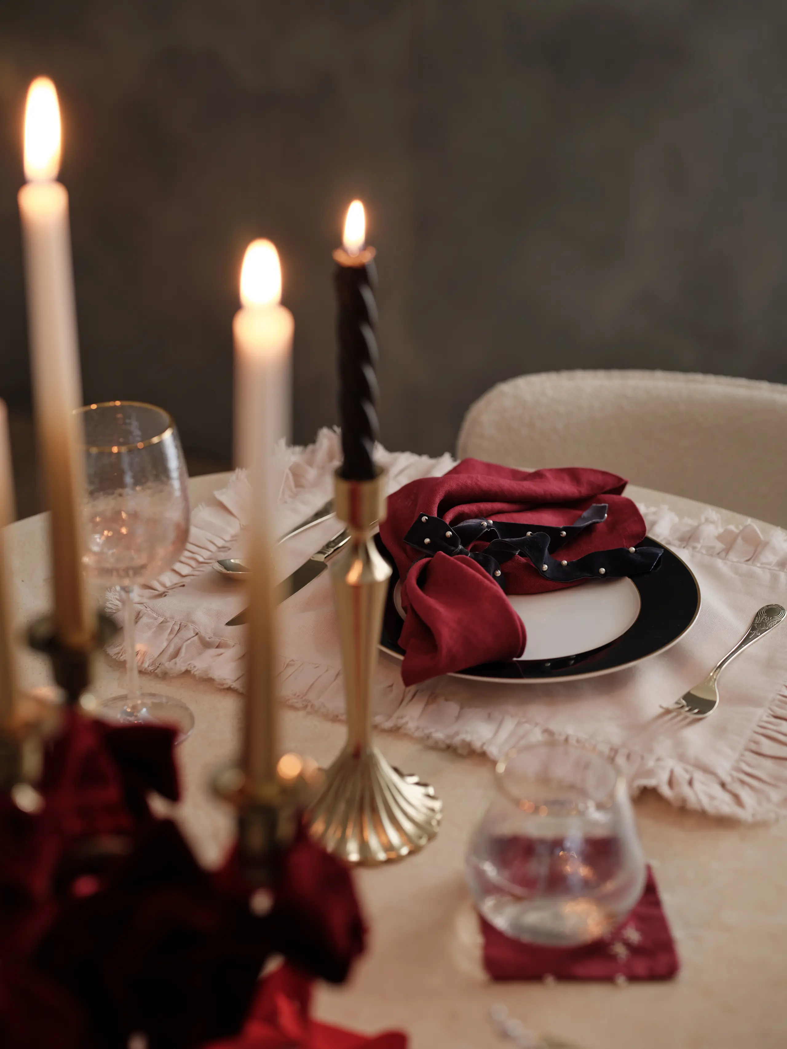 Image of festive table deco including candles and plates 