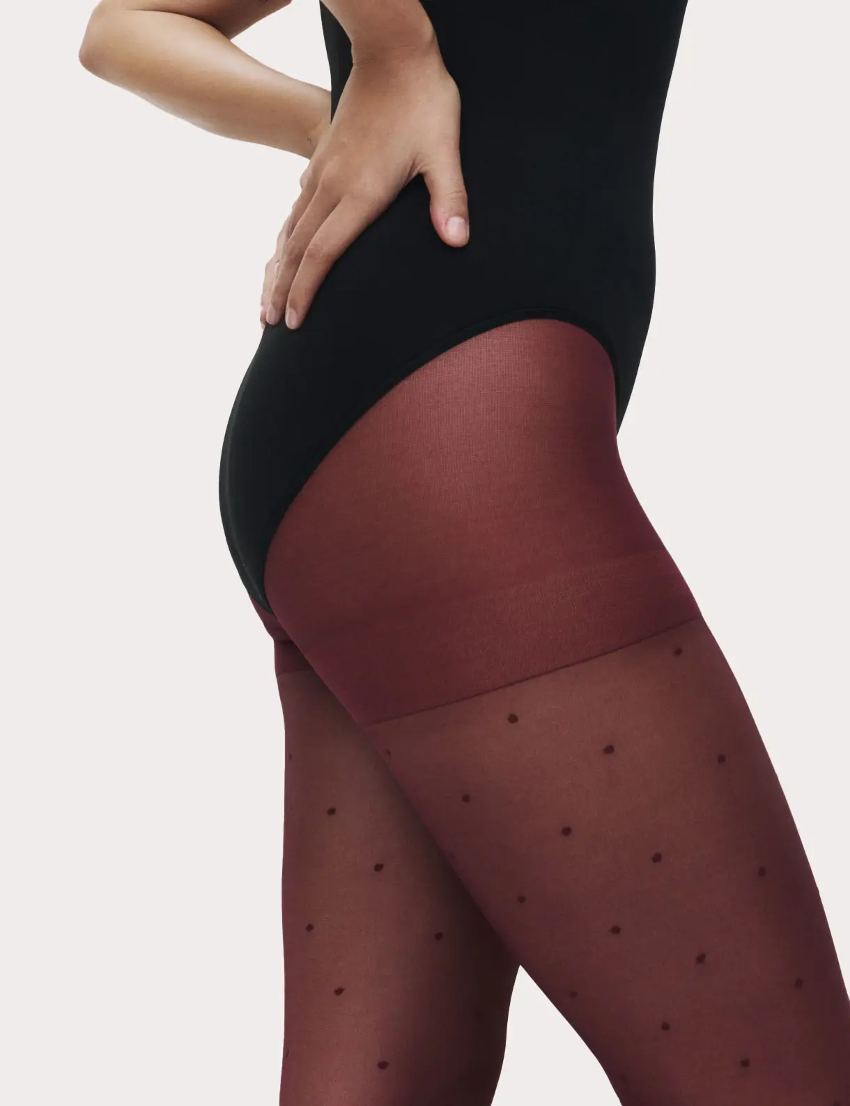 Woman wearing wine red spotted tights