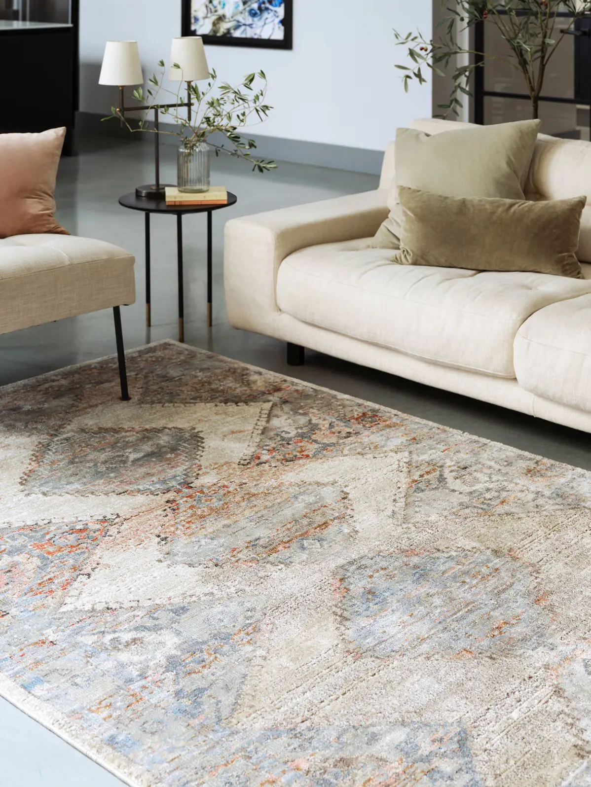 Neutral patterned rug and cream sofa