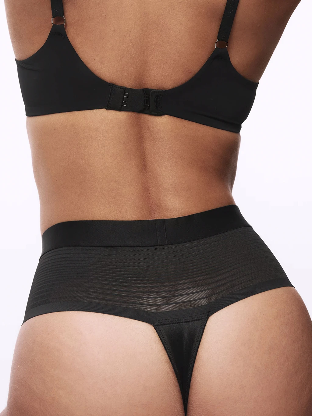 Woman wearing a black bra and thong