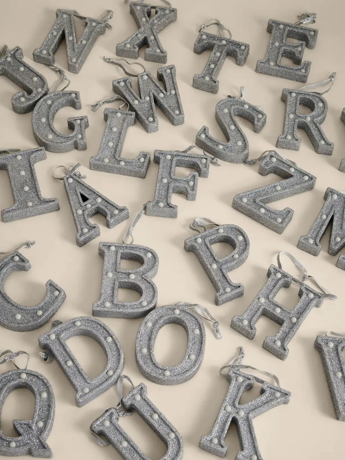Image of an assortment of silver letter hanging decorations 