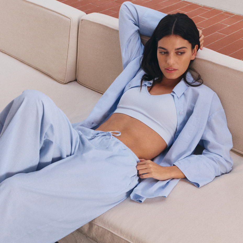 Woman in pyjamas on couch