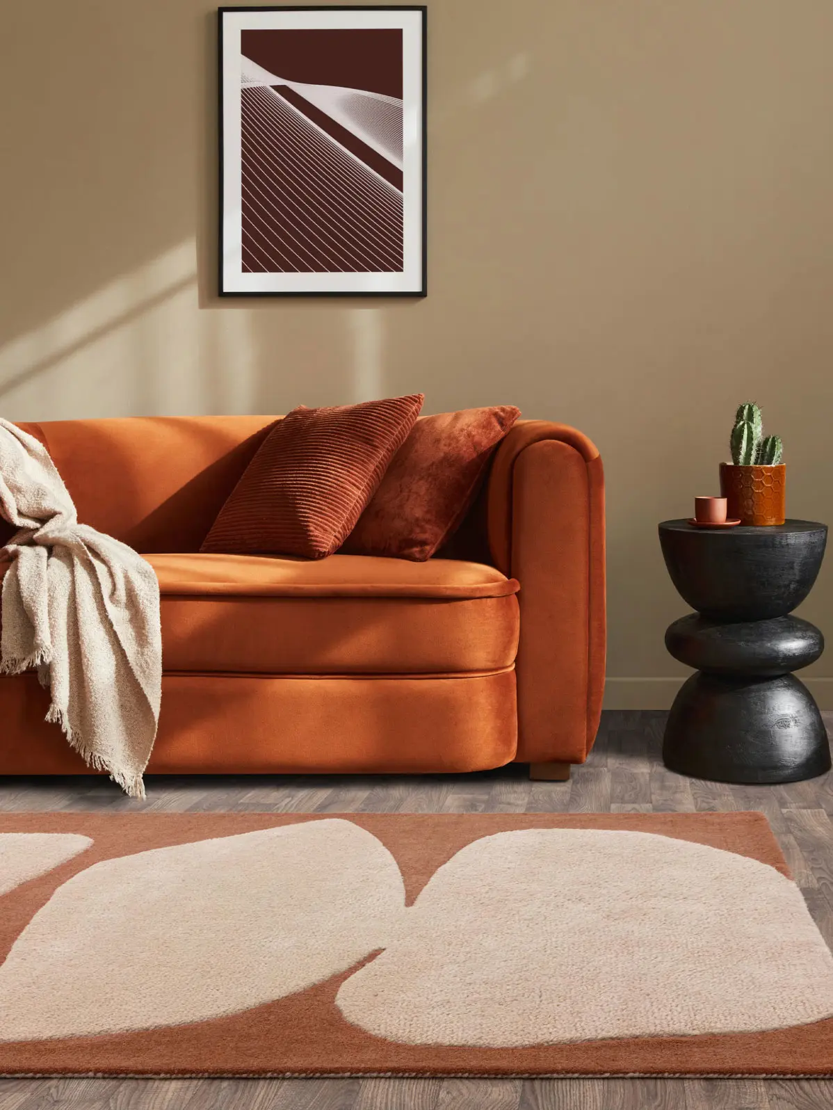 Orange sofa and matching patterned rug 
