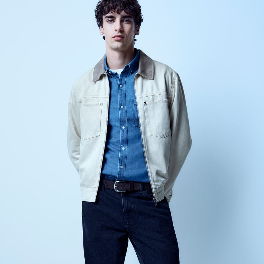 Man wearing white denim jacket, blue denim shirt and dark wash jeans