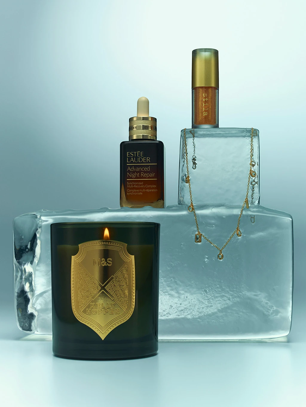 Group of presents including an M&S x Kelly Hoppen candle, jewellery and skincare.