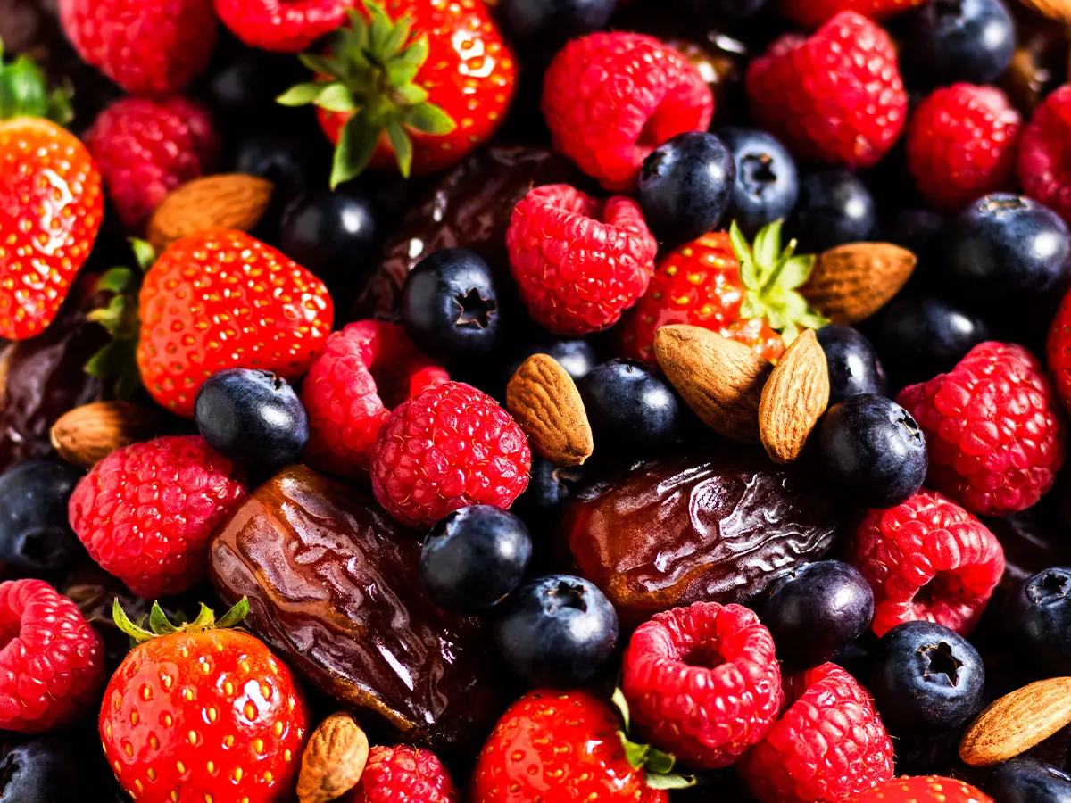 A selection of fresh berries, dates and almonds.