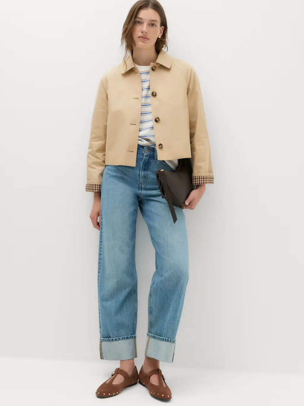 Woman in trench coat and jeans