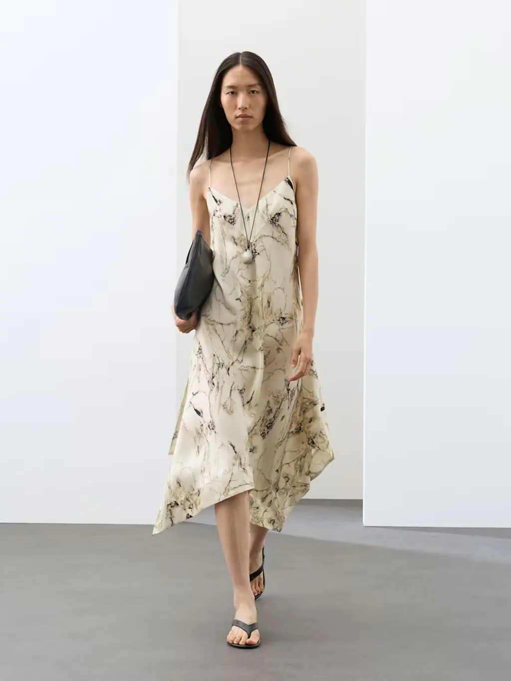Woman wearing a printed satin midi dress with black heels