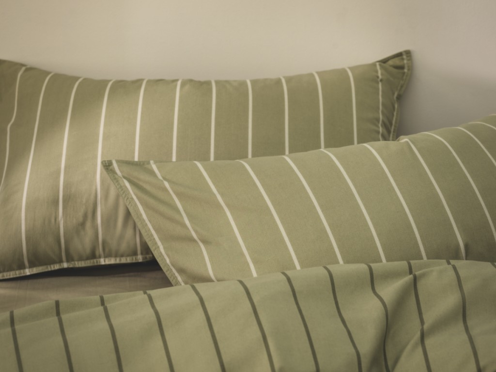 Pillows with green pillow cases with embossed stripe