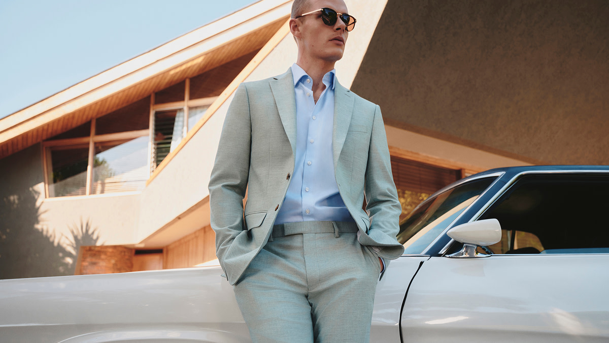 Man wearing pastel green suit and sunglasses 