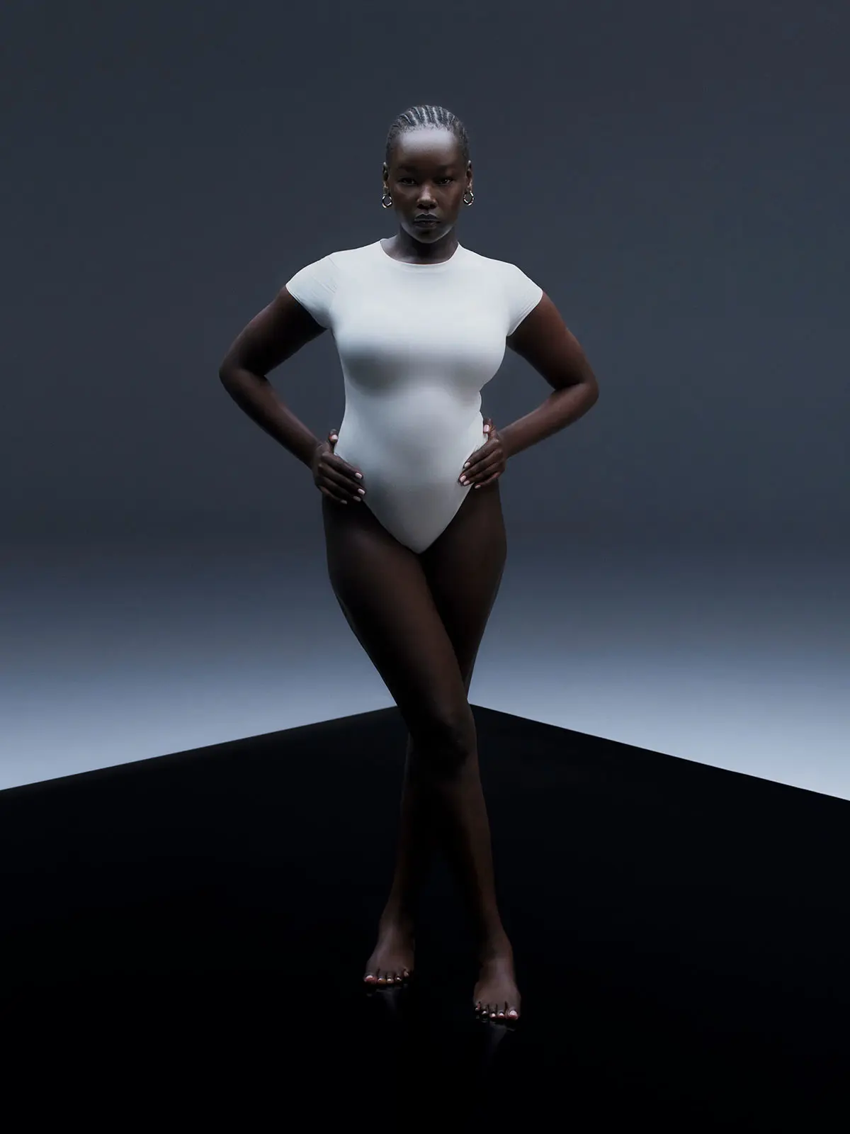 Woman wearing white bodysuit 