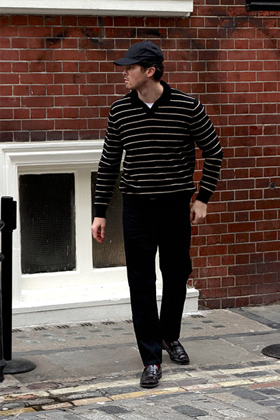 man in striped jumper looking to the side