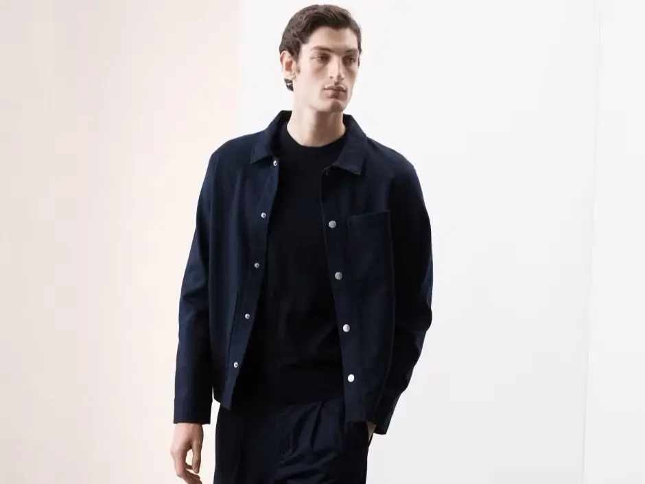Man wearing navy jacket and black jeans at M&S