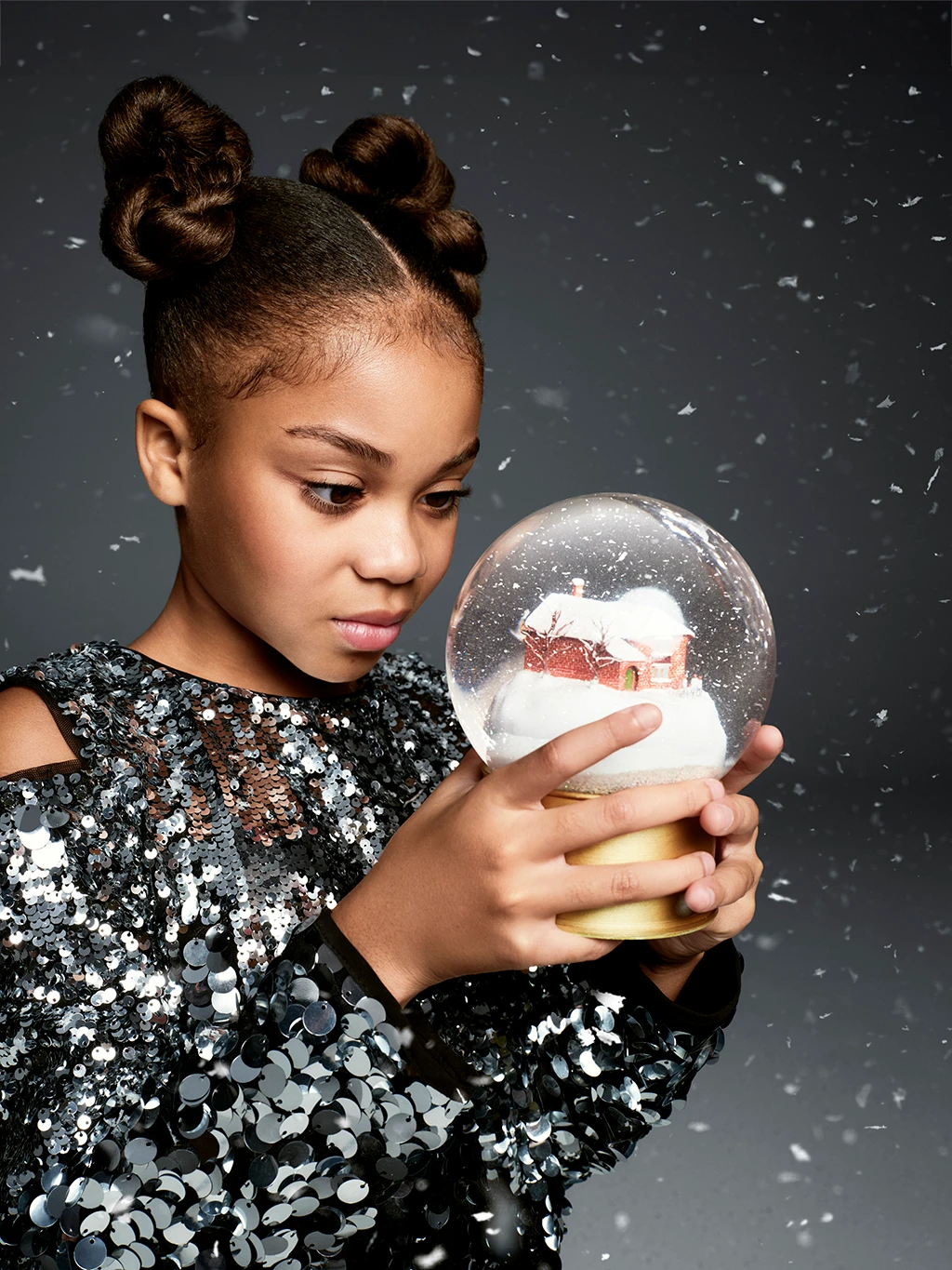 Skylar Blue looking into a magic snow globe in The M&S Christmas advert