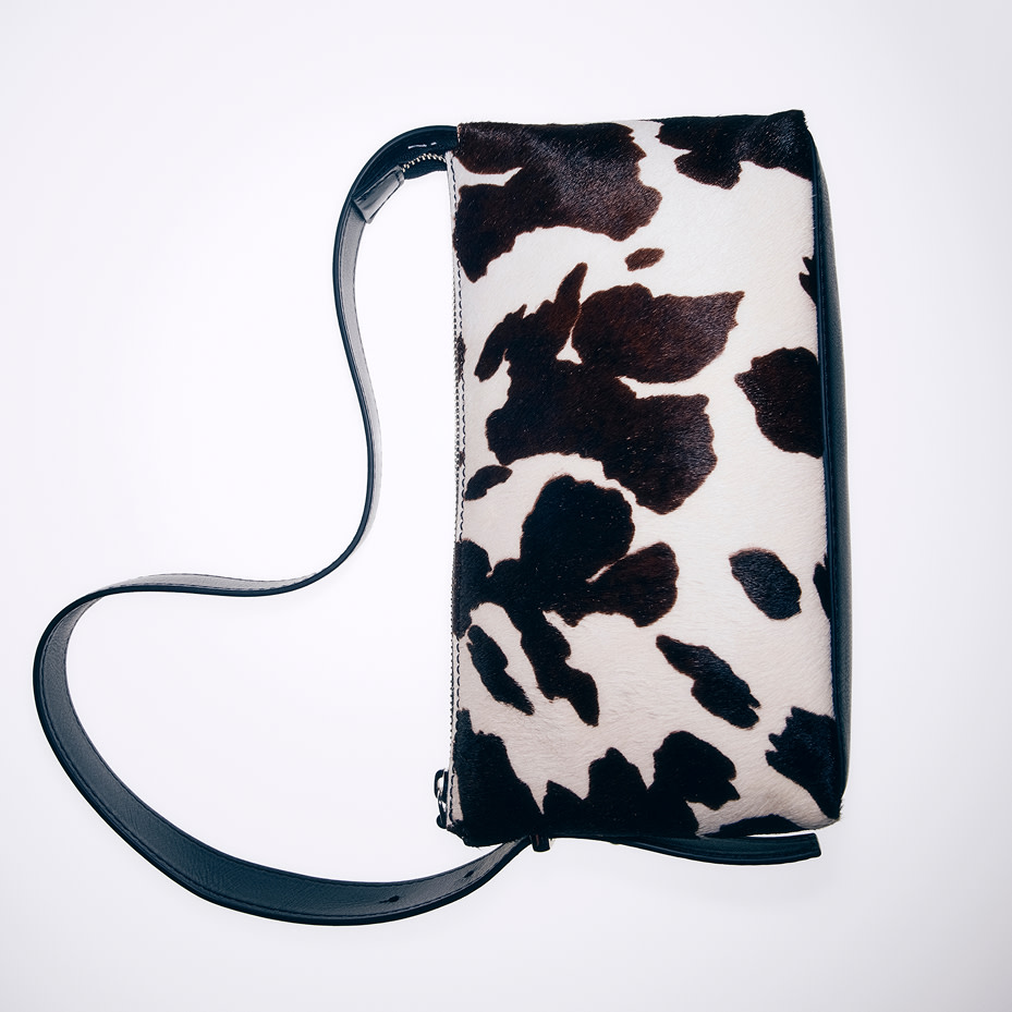 A cow-print leather handbag
